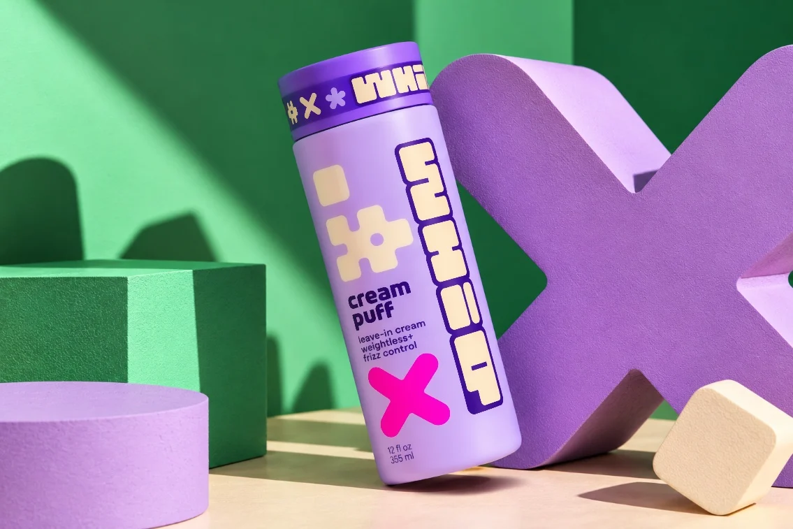 cream puff leaning on a giant purple x